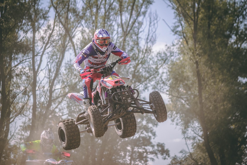 person riding red and black ATV