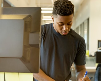 man writing on white paper