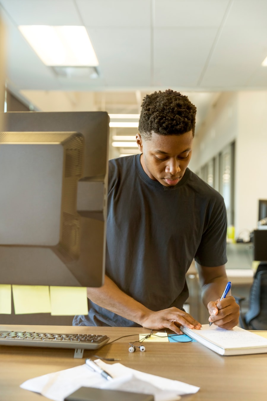 Operations manager reviewing workflow data on a large monitor in a warehouse