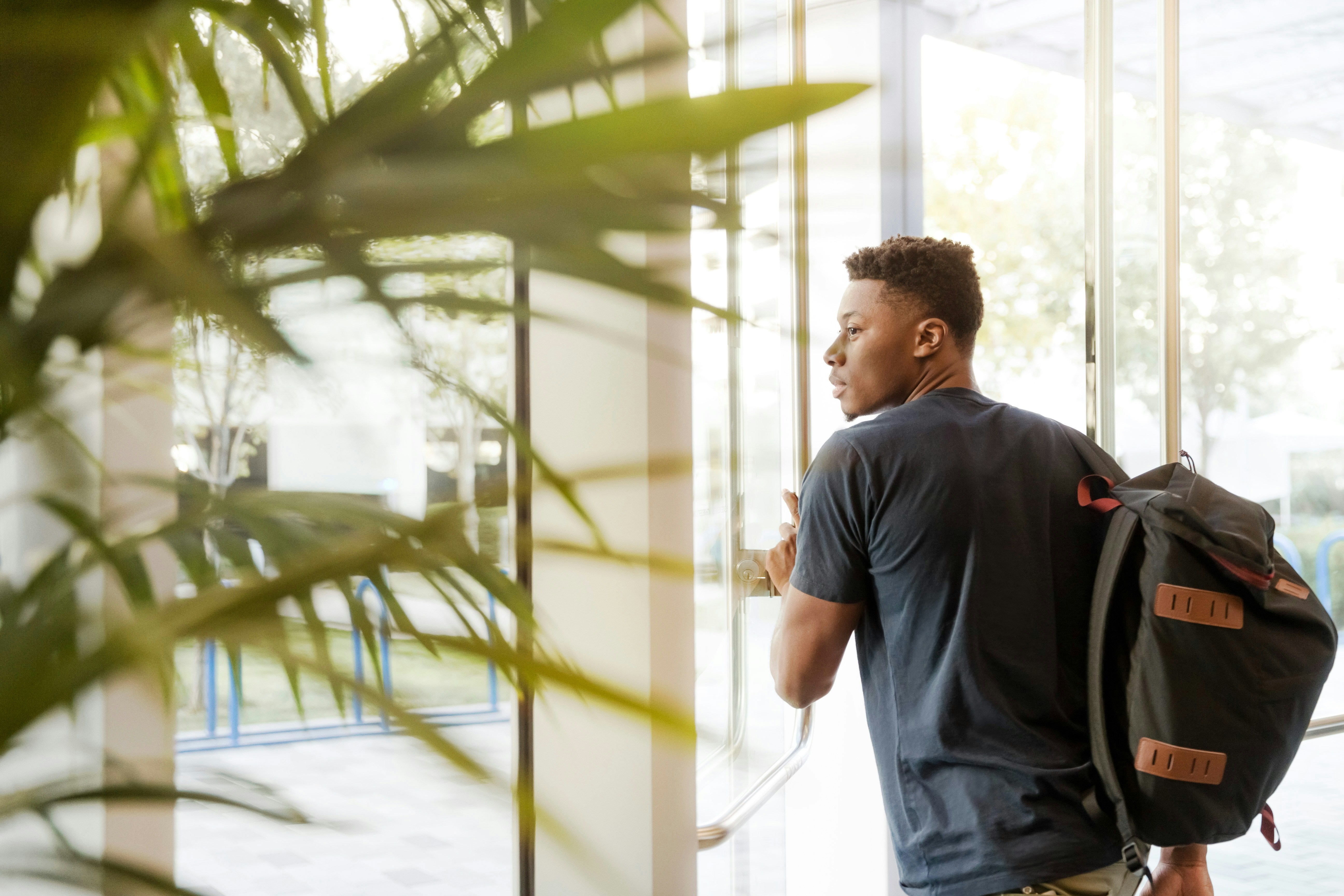 student opening the building door 