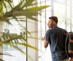 man holding glass door