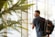 man holding glass door