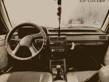 Car accessories including a steering wheel cover, maintenance tools, and insurance documents.