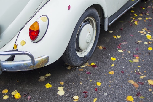 white Volkswagen Beetle on road