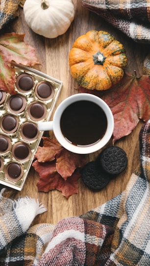 A cozy table setting featuring handmade butterscotch treats with autumn leaves scattered around.