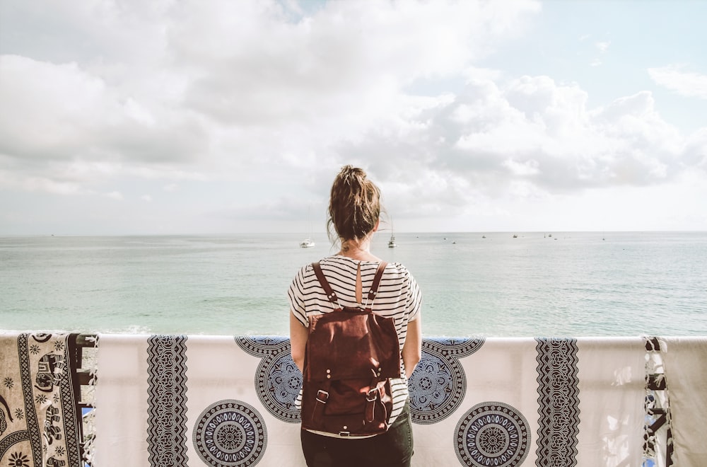 woman standing in front of body of water during daytime