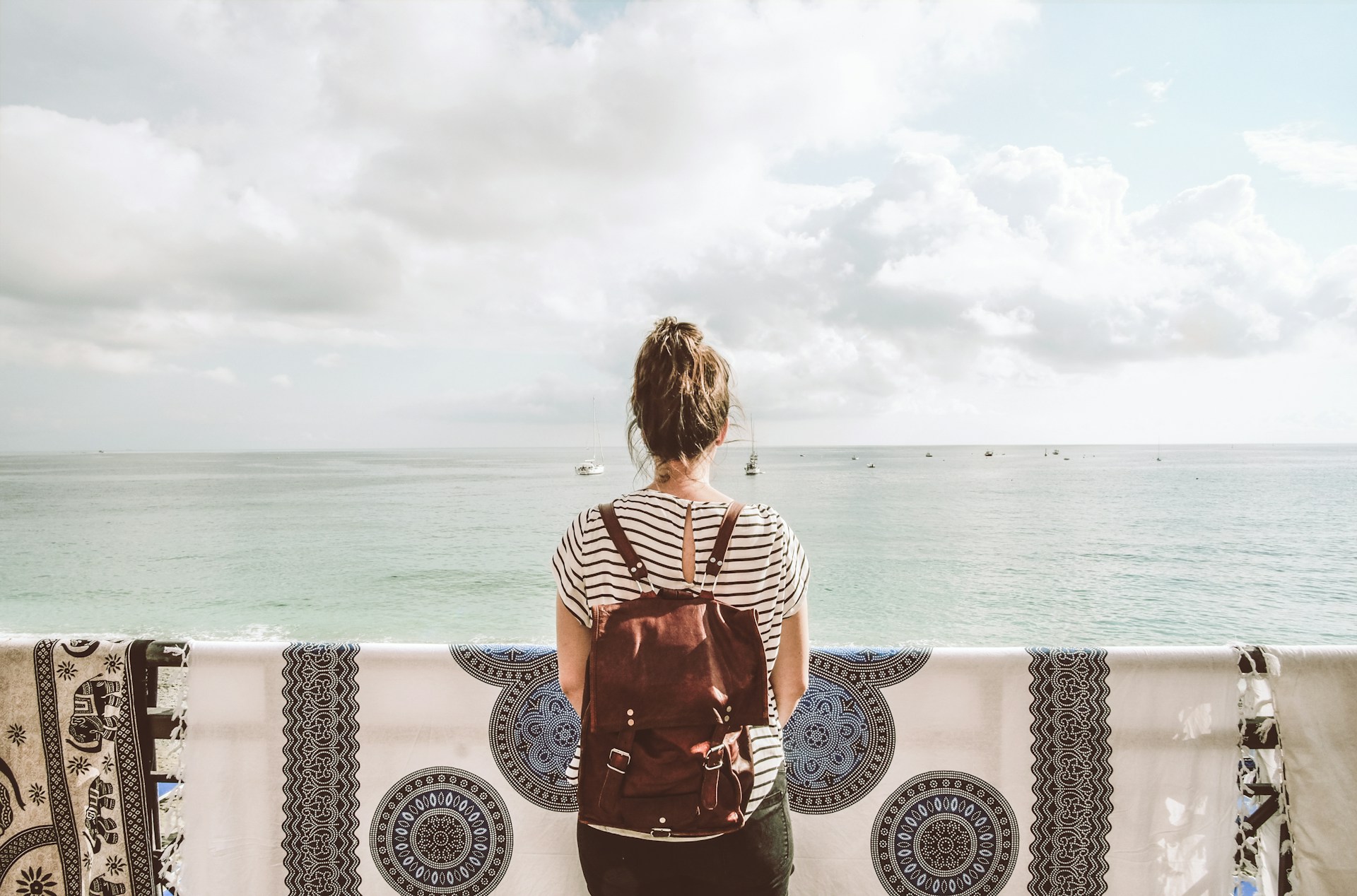 woman standing in front of body of water during daytime