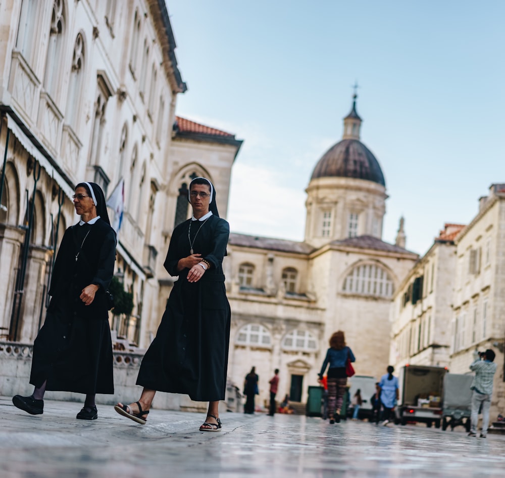 two nun walking in front of cathedral