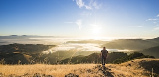 man walking on mountain during daytime