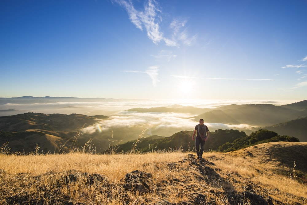 man walking on mountain during daytime