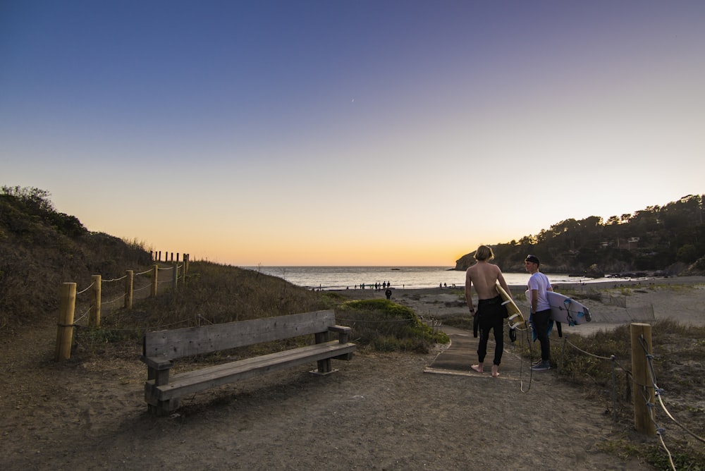 man and woman walking on wooden dock during daytime