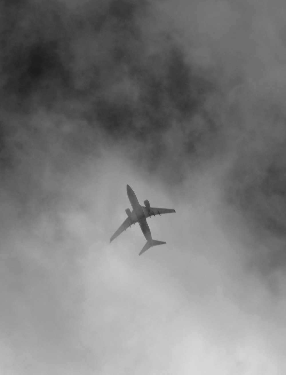 an airplane is flying through the cloudy sky