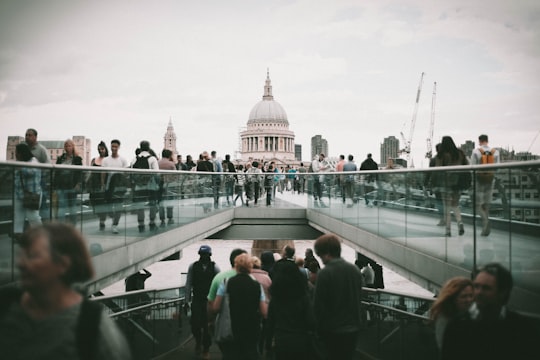 people walking in front of white concrete dome building during daytime in St Paul's Cathedral United Kingdom