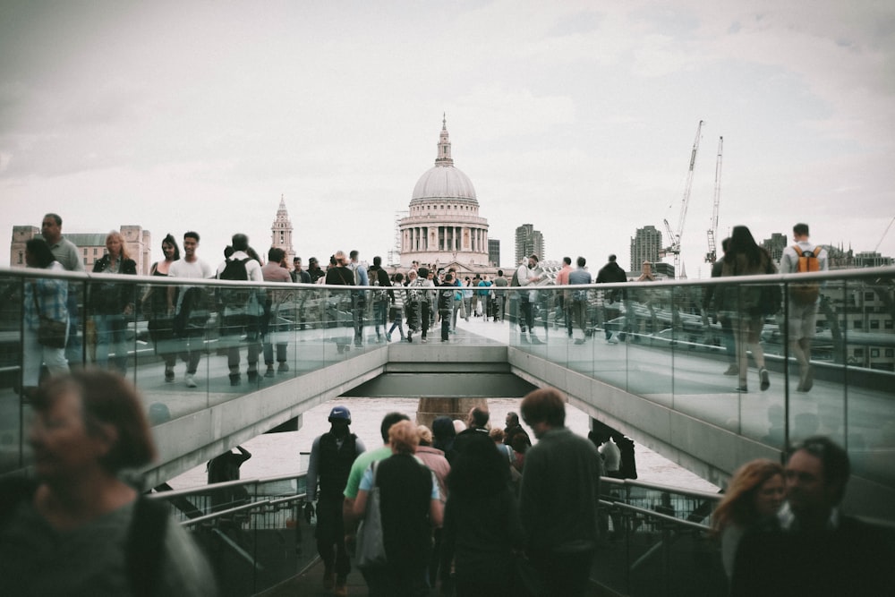 people walking in front of white concrete dome building during daytime