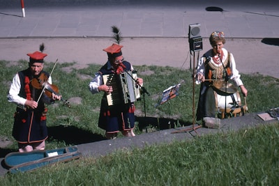 Musicians performing traditional Maltese music during a sunny outdoor event.