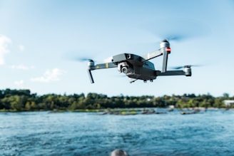 black DJI Mavi quadcopter near body of water