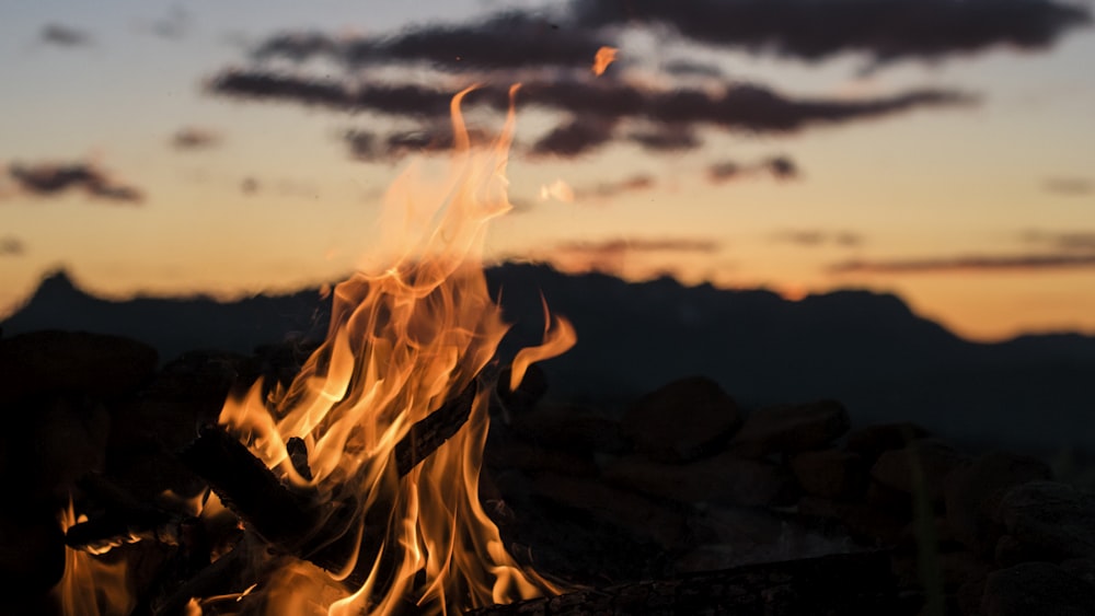 bonfire overlooking silhouette of mountain golden hour photography