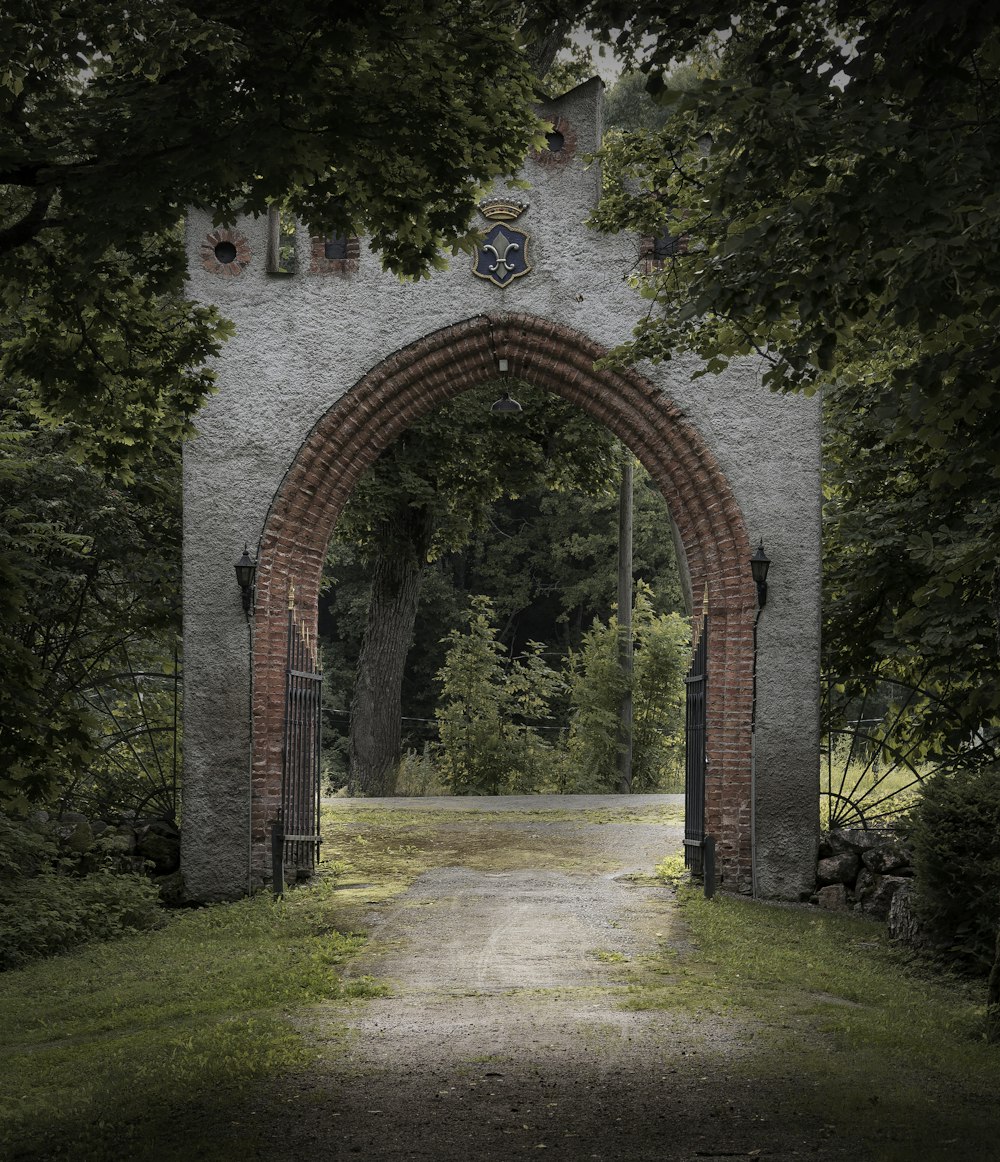 brown brick arch with green grass field