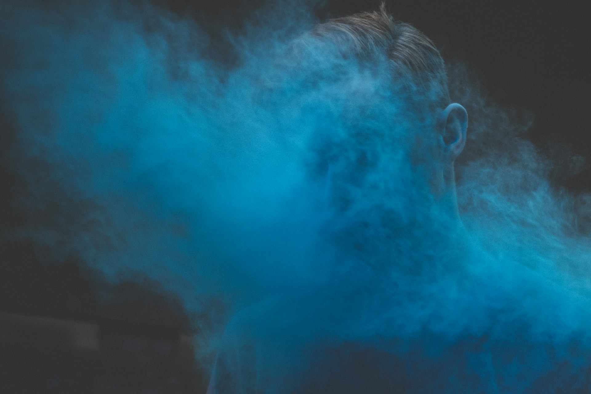 man's face covered with smoke