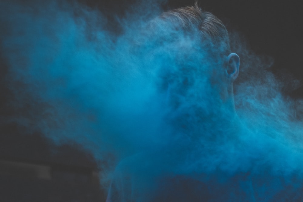 man's face covered with smoke