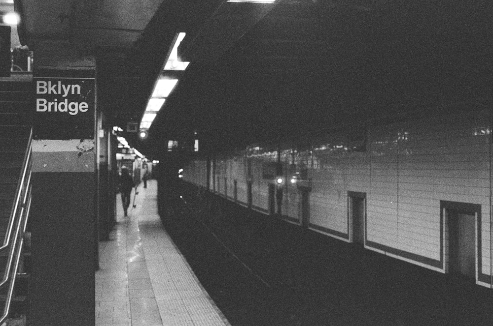 grayscale photography of Brooklyn Bridge subway