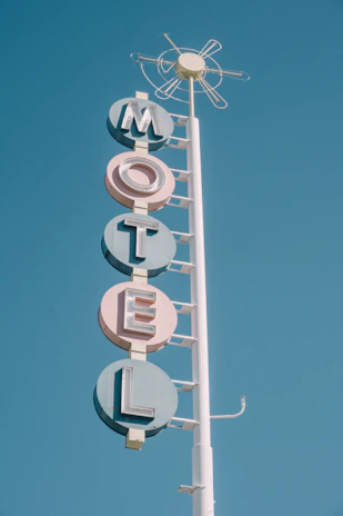white and teal metal motel signage