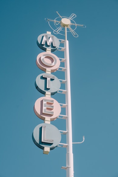 white and teal metal motel signage