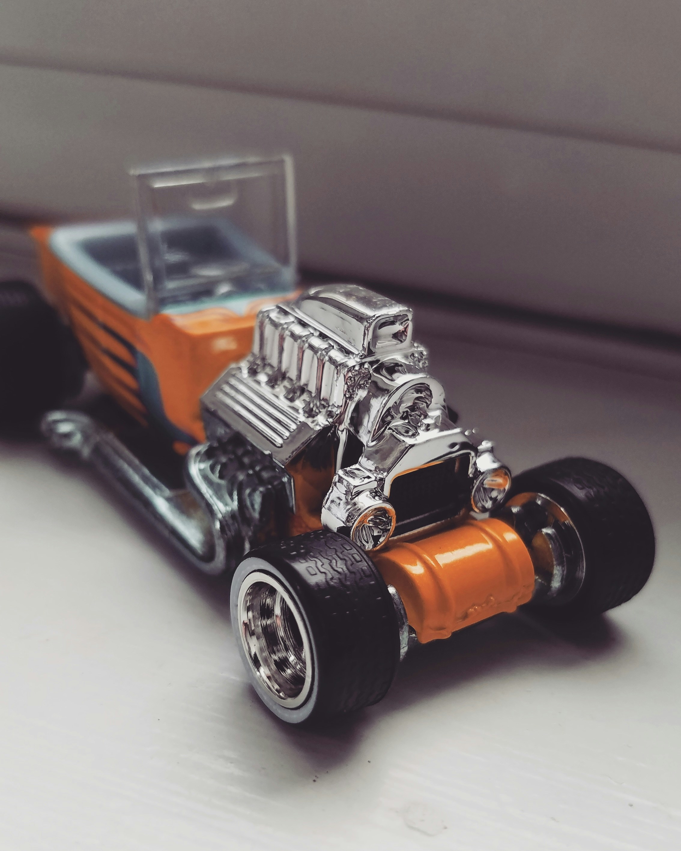Classic hot rod toy car in orange Spectraflame paint