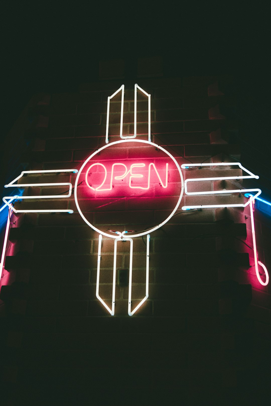 red and white open neon light signage