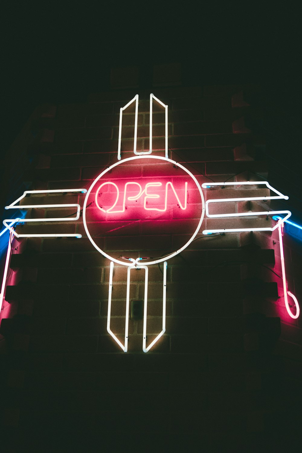 red and white open neon light signage