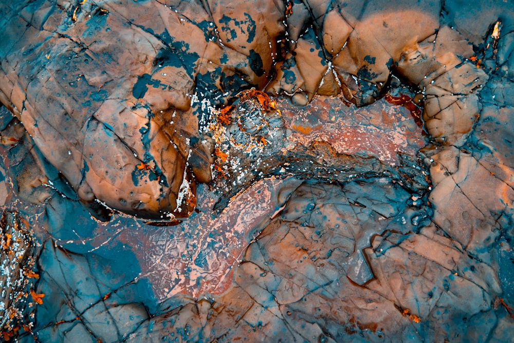 an aerial view of a rock formation with blue and brown colors