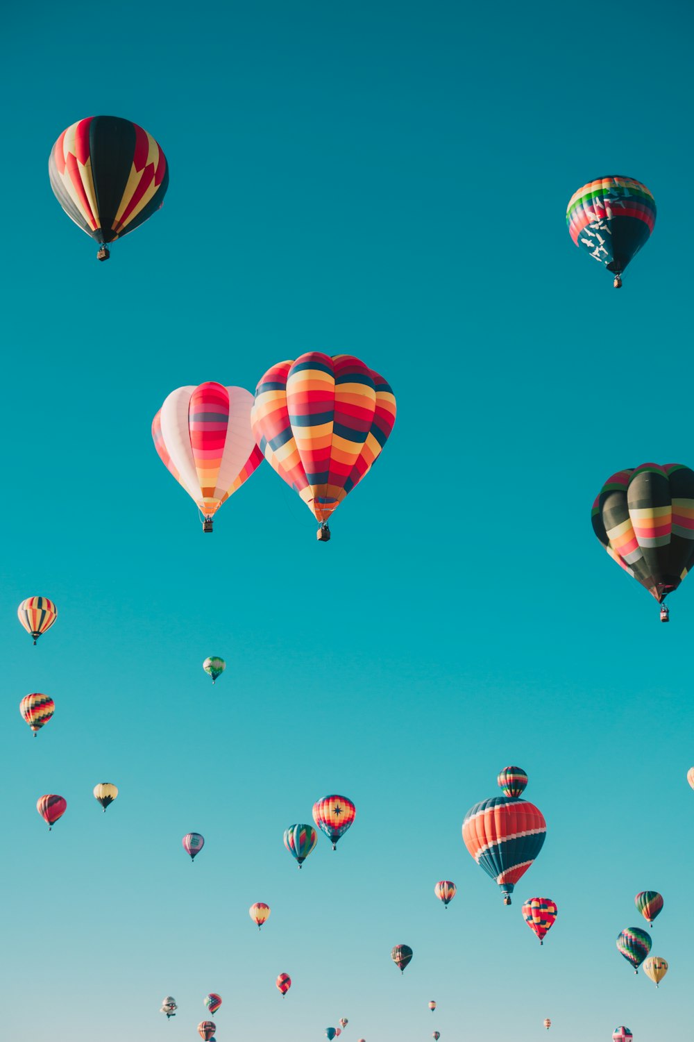 assorted hot air balloons flying at high altitude during daytime