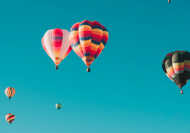 assorted hot air balloons flying at high altitude during daytime