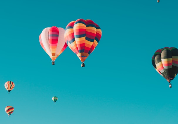 assorted hot air balloons flying at high altitude during daytime