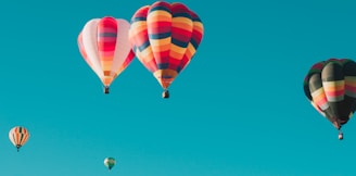 assorted hot air balloons flying at high altitude during daytime