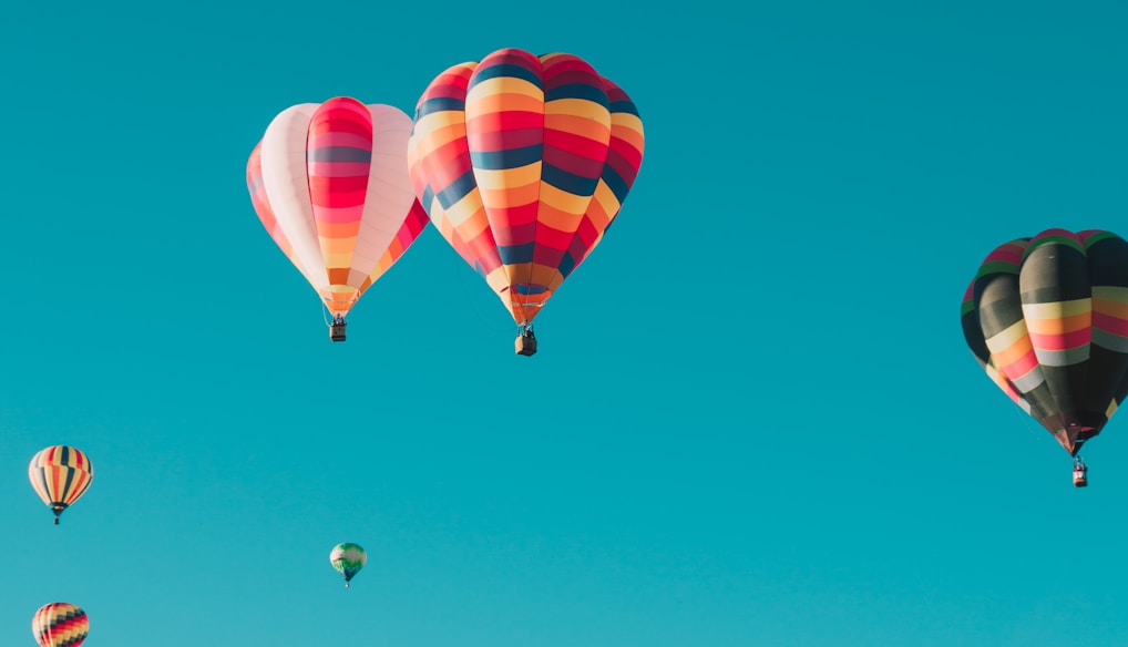 assorted hot air balloons flying at high altitude during daytime