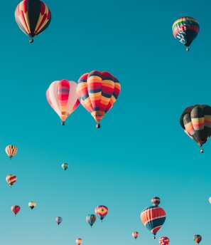 assorted hot air balloons flying at high altitude during daytime