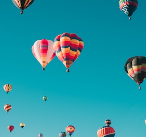 assorted hot air balloons flying at high altitude during daytime