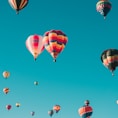 assorted hot air balloons flying at high altitude during daytime