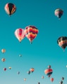 assorted hot air balloons flying at high altitude during daytime