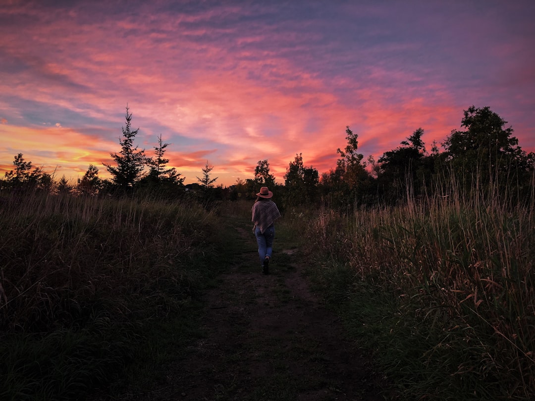 woman standing in between grasses