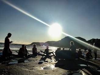 Happy surf camp participants sharing a moment on the beach after a day of lessons.