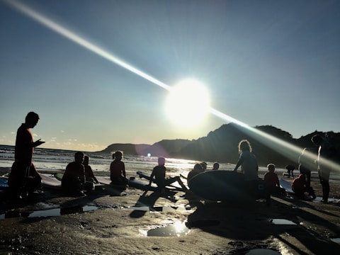 Group of riders sharing Evergrom boards on a sunny beach.