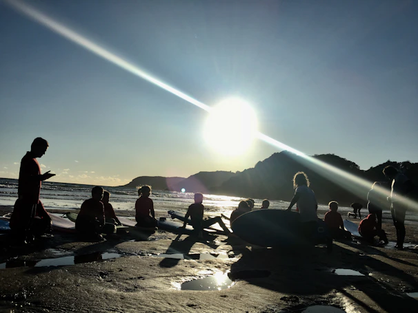Happy surf camp participants sharing a moment on the beach after a day of lessons.