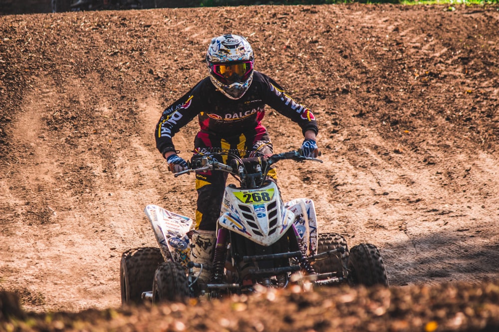 man riding ATV quad bike during daytime