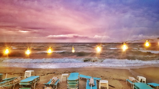 Sunset view over North Goa’s Baga Beach with festival lights glowing.
