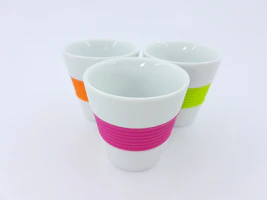 A colorful set of insulated travel cups arranged neatly on a shelf