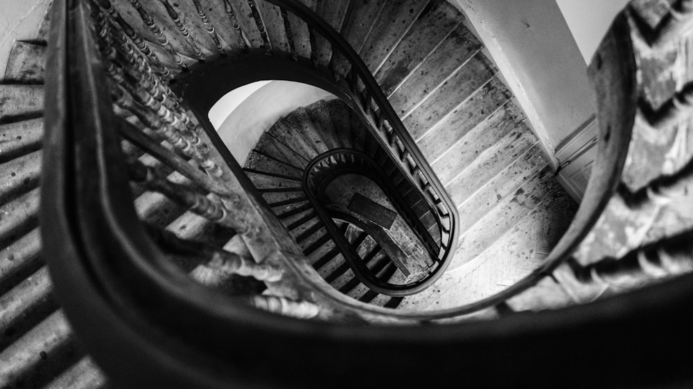 grayscale photo of spiral stair