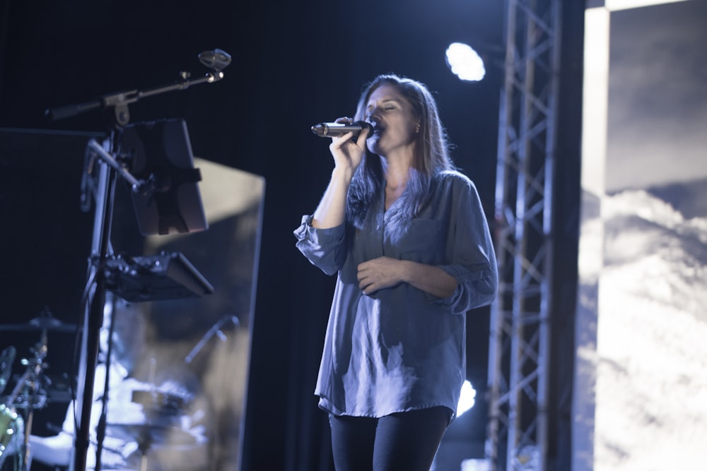 woman holding microphone on stage