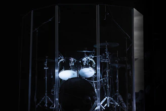 A modern drum kit set against a dark background, emphasizing its silent design.
